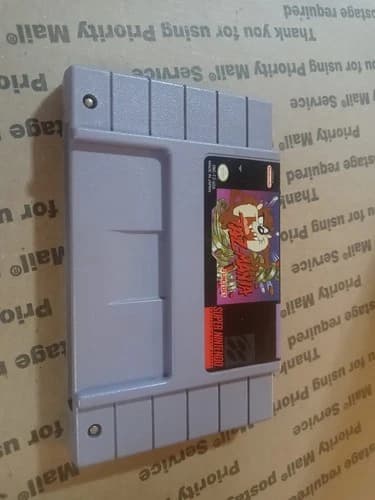 Taz-Mania SNES Cartridge Super Nintendo. Shipping bmwt an insurance.